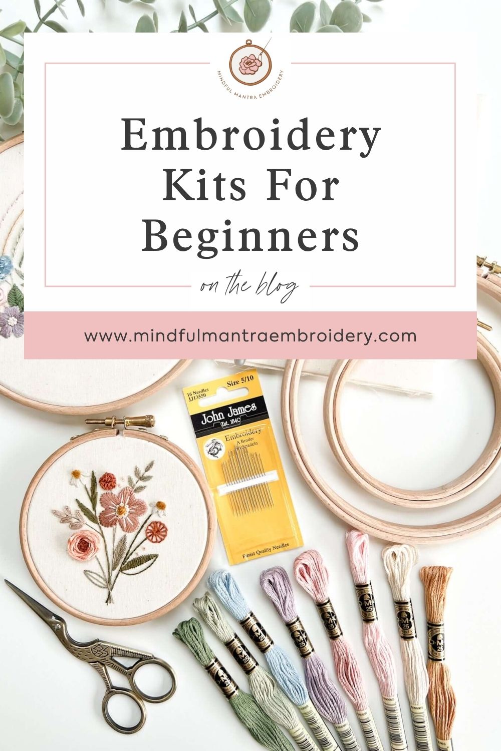 Embroidery kits for beginners laid out and displayed with threads and hoops.