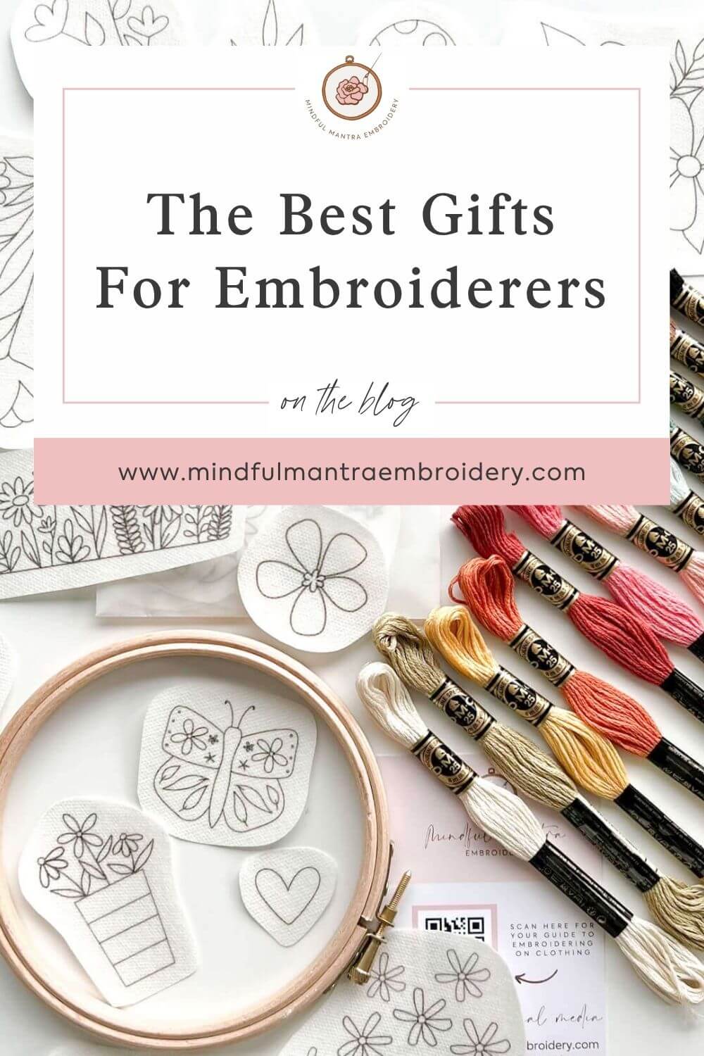 Gifts for embroiderers laid out on a flat surface, including thread, patterns and an embroidery kit