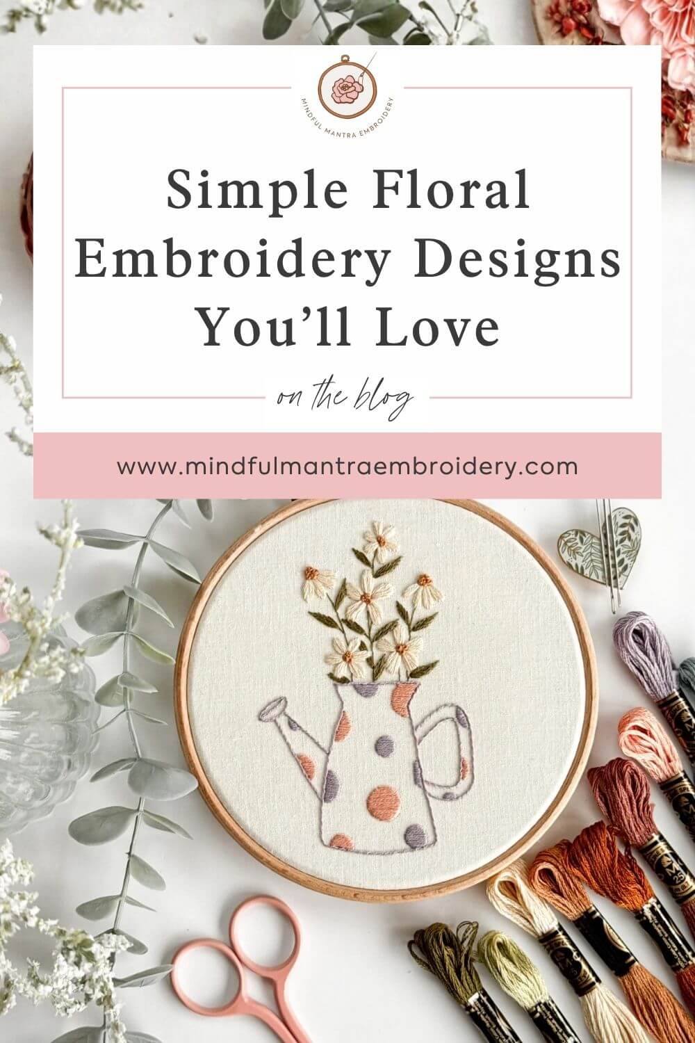 A simple floral embroidery design surrounded by scissors and DMC thread