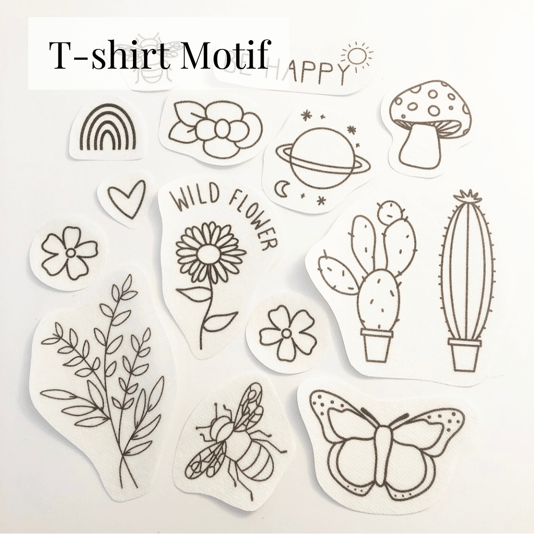 stick and stitch embroidery patterns for T-shirts spread out on a flat surface