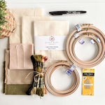 Beginner Embroidery Kit featuring fabric bundle, embroidery hoops, and threads for beginners.