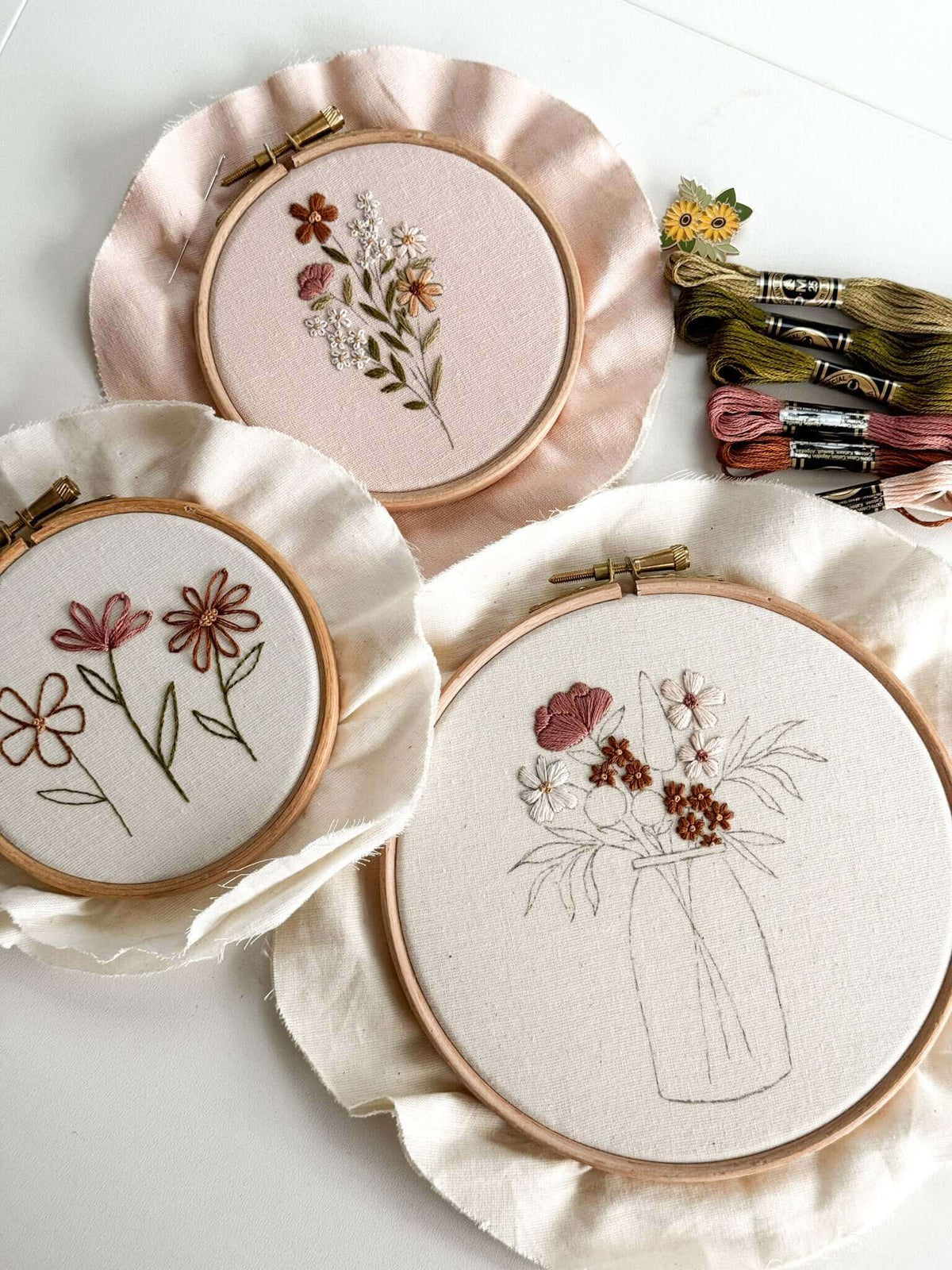 Beginner Embroidery Kit featuring three floral embroidery hoops and colorful threads for easy stitching projects.
