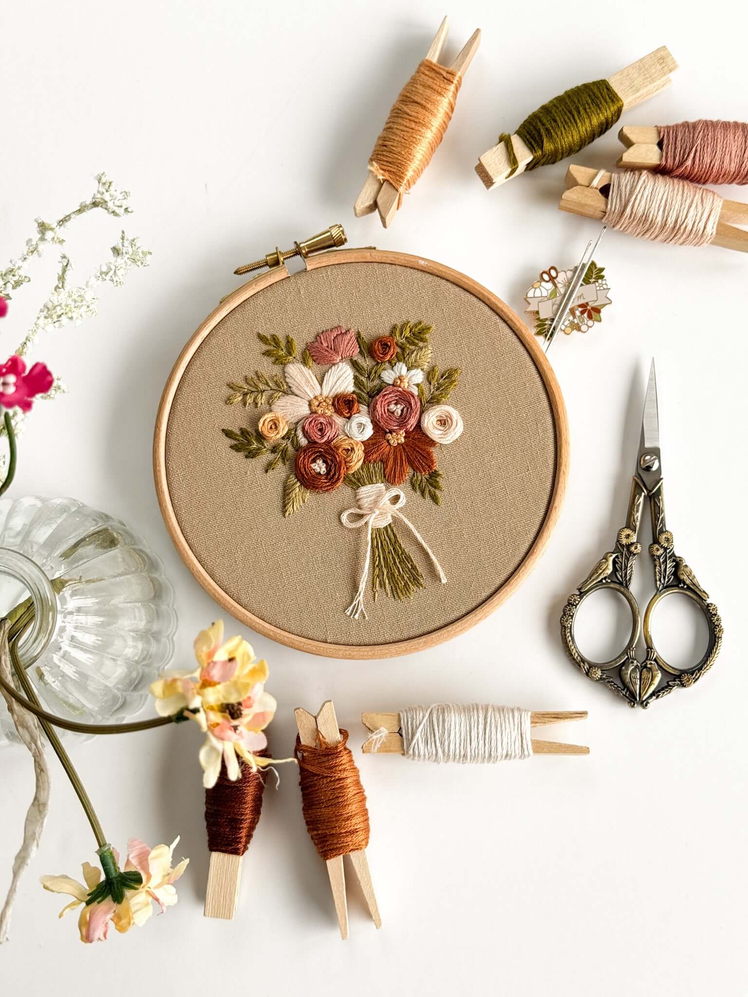 Beginner Embroidery Kit featuring a beautiful flower bouquet design with embroidery supplies arranged around it.