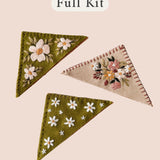 Felt Bookmark Embroidery Kit with three embroidered bookmarks in green and pink with floral designs.