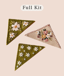 Felt Bookmark Embroidery Kit with three embroidered bookmarks in green and pink with floral designs.