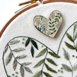 The botanical heart magnetic needle minder attached to an embroidered heart