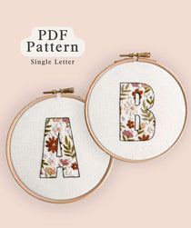 The letters 'A' and 'B' stitched using the Floral-Filled Letters embroidery pattern