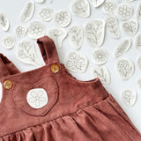  Floral embroidery designs with an example of how they can be embroidered onto baby clothes