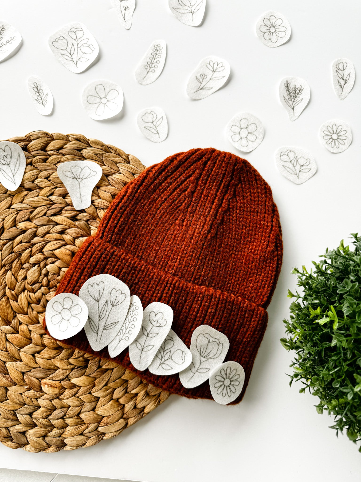  Floral embroidery designs with an example of how they can be embroidered onto a woolly hat