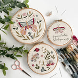 Wildflower Wings Butterfly Embroidery Pattern Bundle displayed in three hoops with floral designs and embroidery supplies.