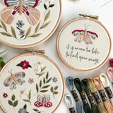 Wildflower Wings Butterfly Embroidery Pattern Bundle with colorful designs and embroidery threads displayed.