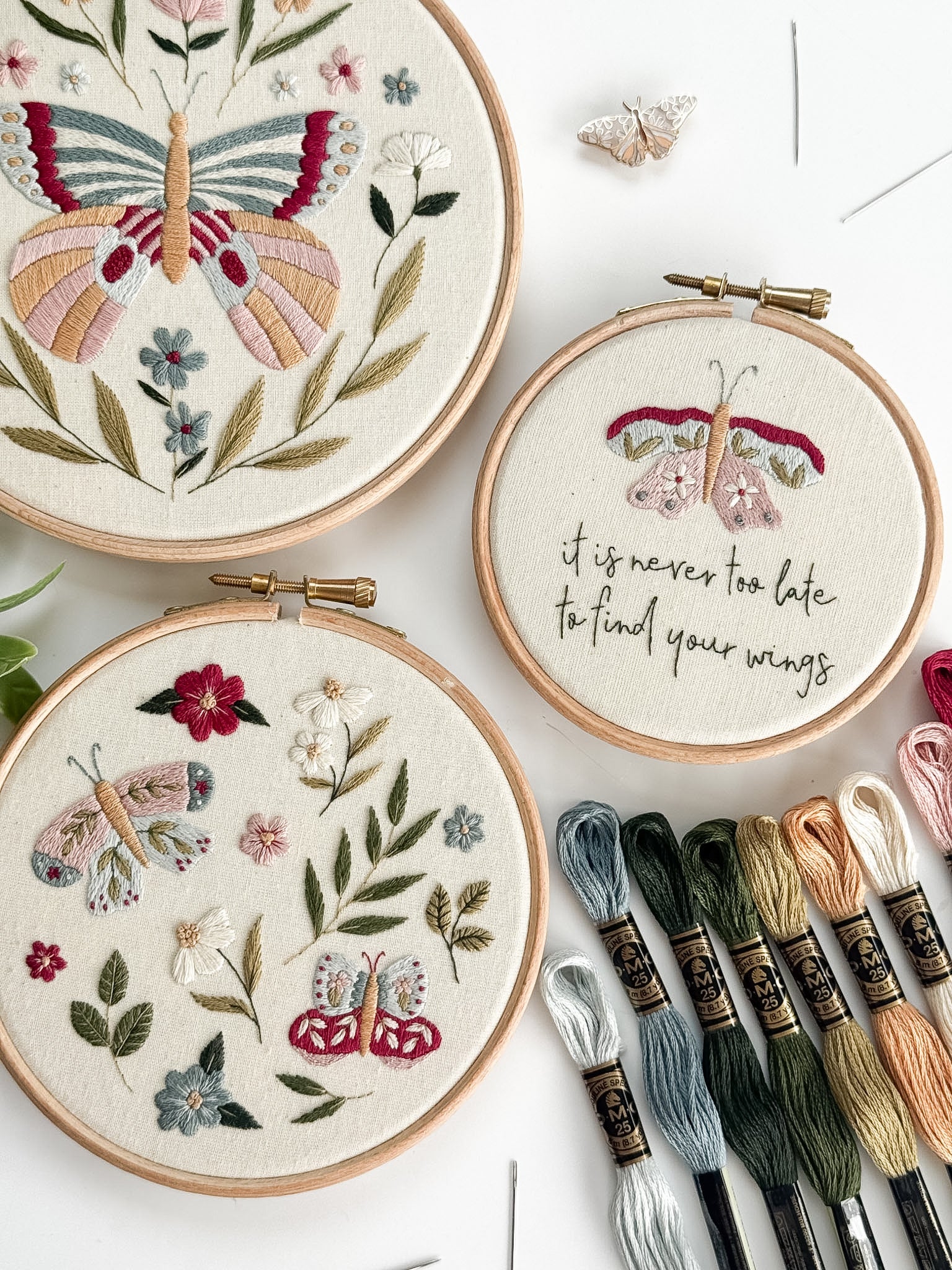 Wildflower Wings Butterfly Embroidery Pattern Bundle with colorful designs and embroidery threads displayed.