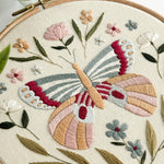 Embroidery hoop with a colorful butterfly and floral design.