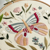 Embroidery hoop with a colorful butterfly and floral design.