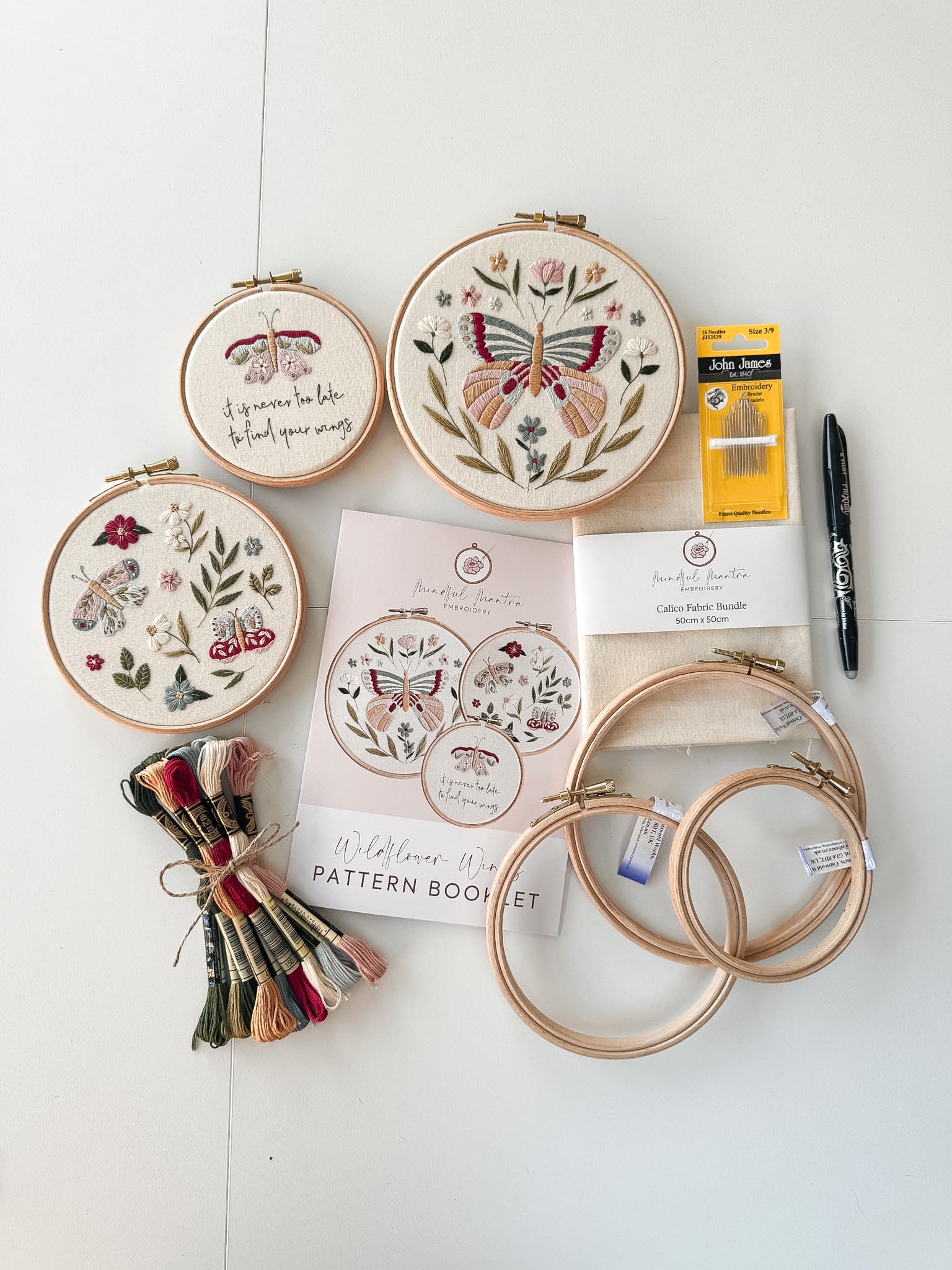 The butterfly embroidery kit featuring hoops, 3 patterns, thread, needles, fabirc and a Pilon FriXion Pen