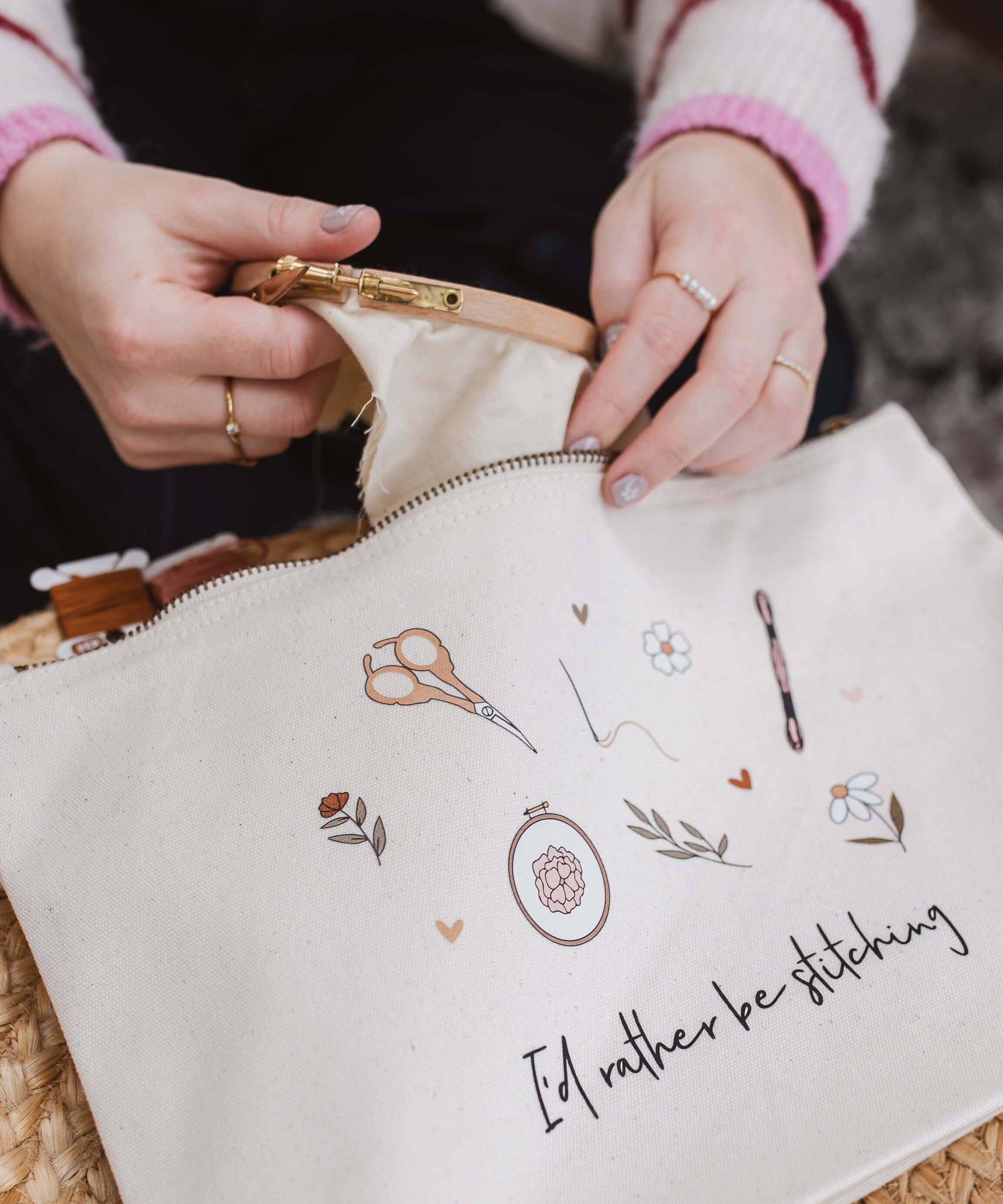 Person opening a white embroidery project bag