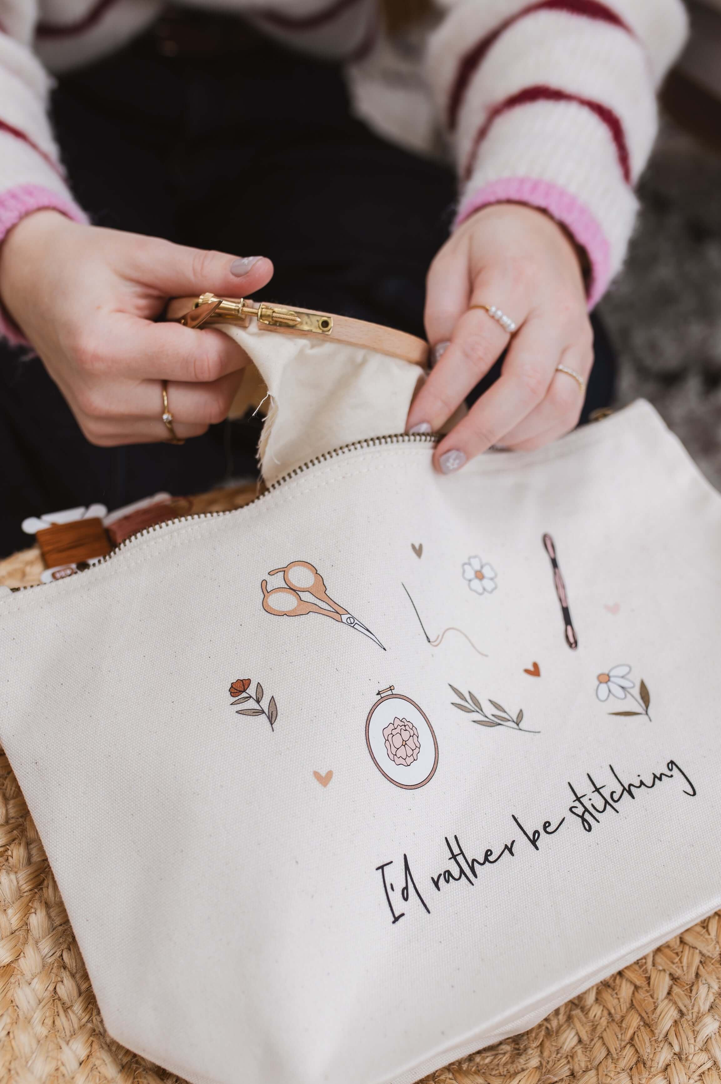 Person opening a white embroidery project bag