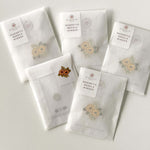 5 packs of magnetic needle minders laid out on a flat surface