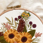 Magnetic Needle Minder with sunflowers on an embroidery hoop, perfect for sewing and needlework projects.
