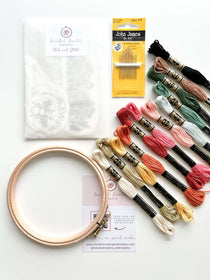 Clothes Embroidery Kit including embroidery hoop, colorful threads, and embroidery needles for beginners.
