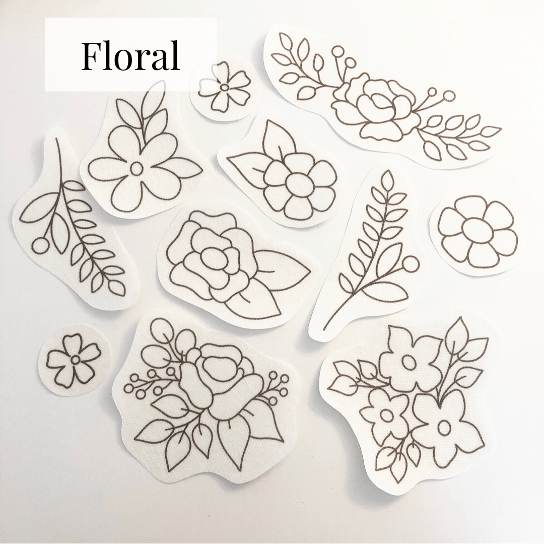 floral stick and stitch embroidery patterns laid out on a table