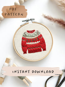 A christmas embroidery pattern with a red and green jumper