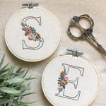 The letters 's' and 'e' stitched using the initial embroidery kit