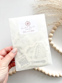 A hand holding a pack of stick and stitch embroidery patterns